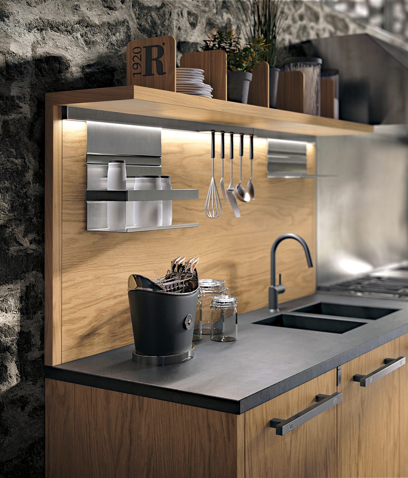 Beleuchteter Arbeitsbereich mit Holzrückwand, aufgehängten Küchenutensilien und einer Spüle.