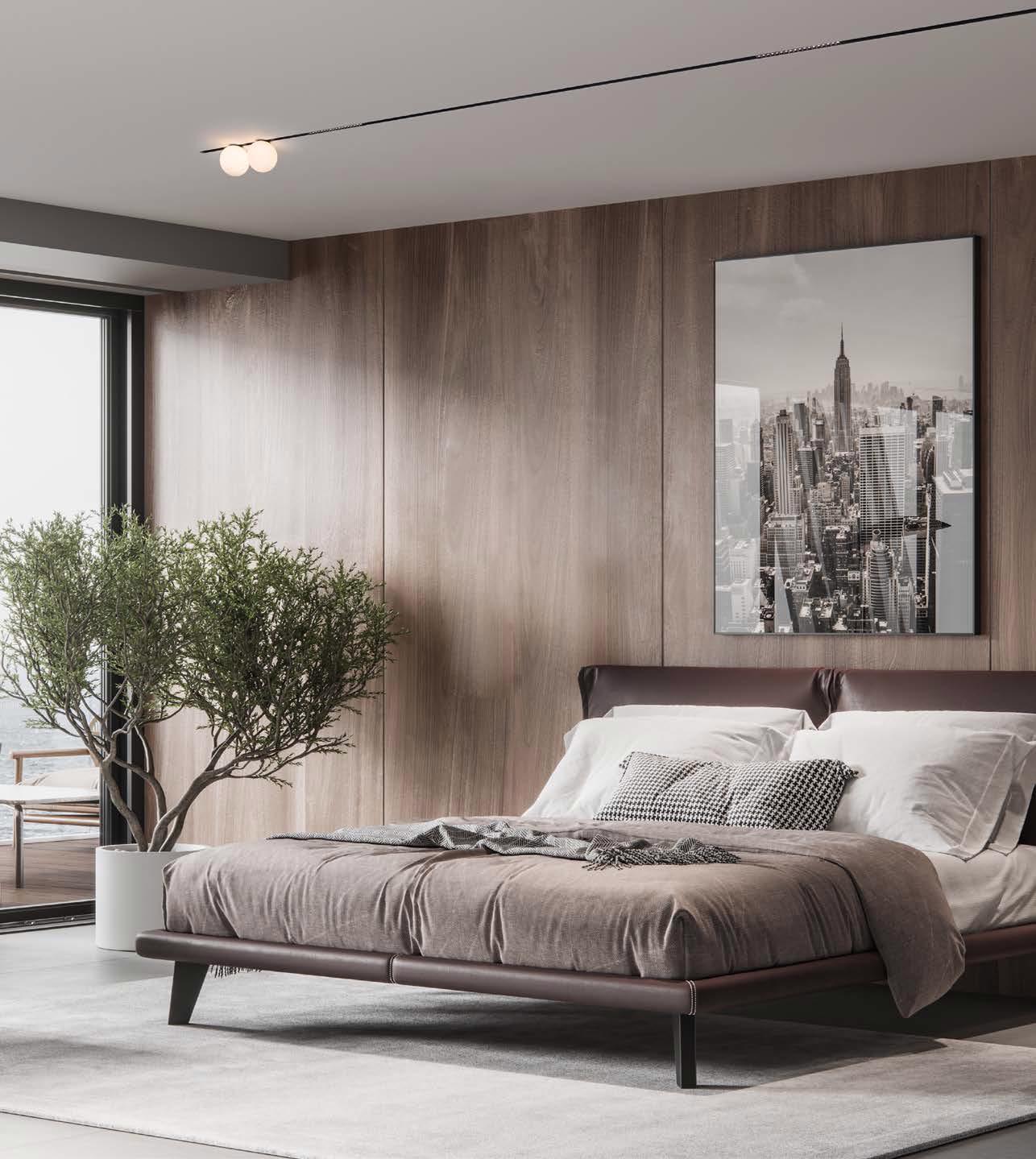 Molto Luce Magnetics: zwei Kugelleuchten an einer schmalen Deckenschiene über einem Bett mit Holzrückwand